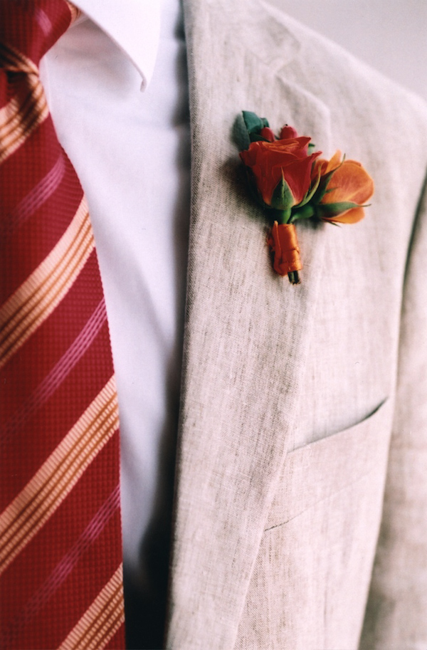 photo by New York City based wedding photographer Karen Hill - red and orange tie and boutonniere detail - menswear accessories